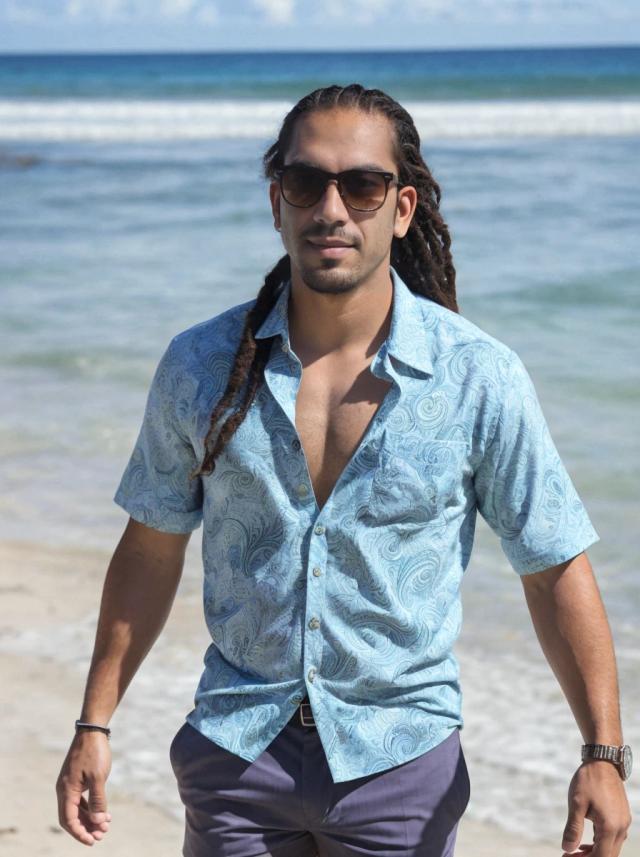 portrait photo of a latino man with dreadlocks walking near the shore, wearing a paisley shirt, shorts, and with sunglasses